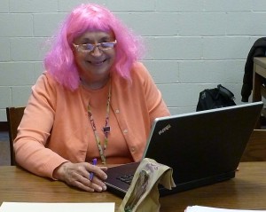 Mrs. Eshbach wearing a purple wig to grant a student's wish. 