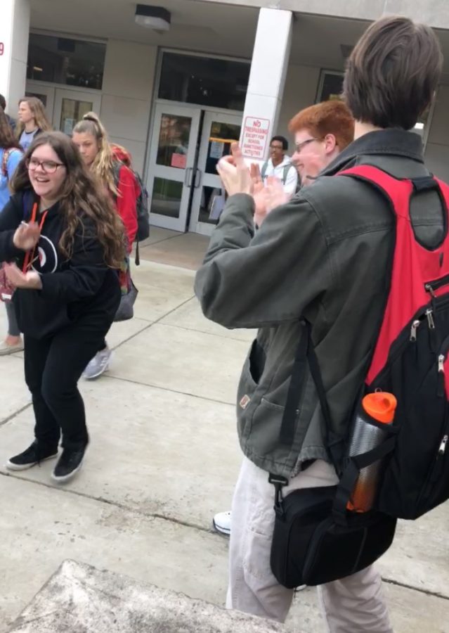 Freshman Stephen Braheny claps for students every day as they leave school.