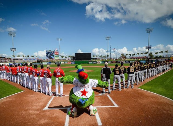 The Phillies and Pirates stand for the national anthem before the Pirates would beat the Phillies 3-2 on Saturday at Spectrum Field in Clearwater, Florida.