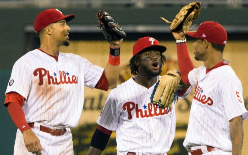 Jul 28, 2017; Philadelphia, PA, USA; Philadelphia Phillies right fielder Aaron Altherr (23) and center fielder Odubel Herrera (37) and right fielder Nick Williams (5) celebrate a victory against the Atlanta Braves at Citizens Bank Park. Mandatory Credit: Bill Streicher-USA TODAY Sports