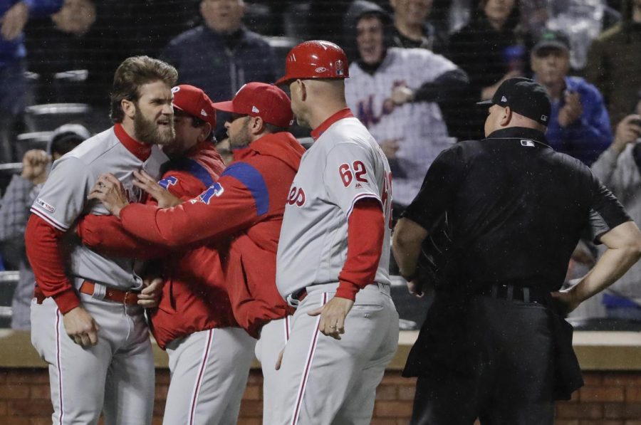 Phillies Bryce Harper has to be restrained by coaches and manager Gabe Kapler after being ejected from the Phillies 5-1 loss to the Mets on Monday night.