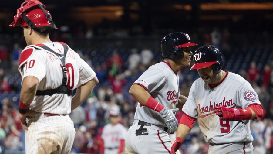 Nationals Juan Soto and Brian Dozier score while Phillies JT Realmuto looks on, as the Nationals crushed the Phillies 15-1 on Wednesday.