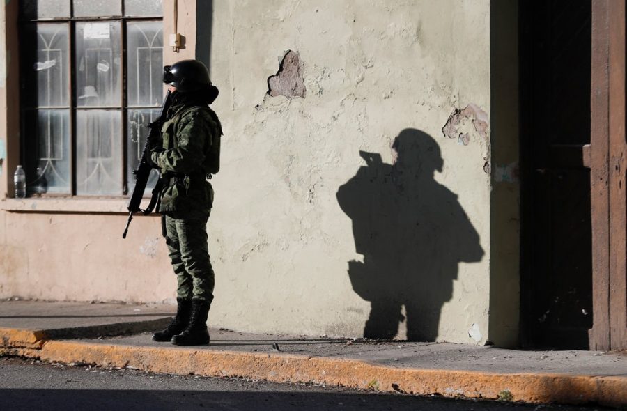 A member of the Mexican security forces standing guard outside City Hall in Villa Union last Tuesday. 