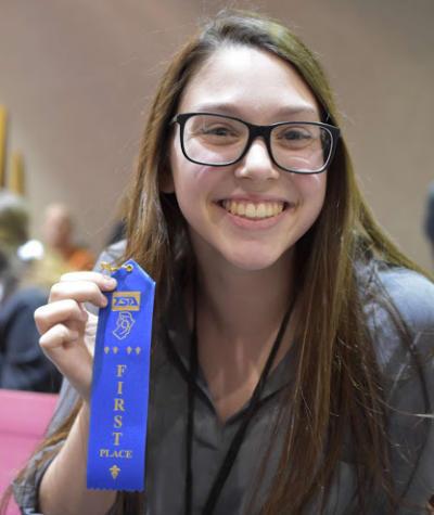 BASH senior Kate Towers proudly displays a winning ribbon