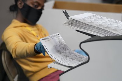 A poll worker counting votes
apnews.com