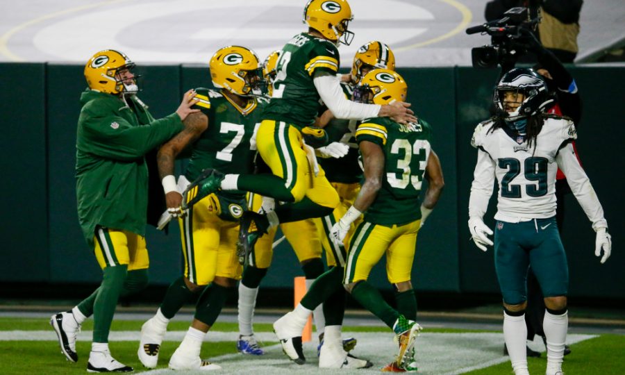 Green Bay Packers Aaron Jones is congratulated by quarterback Aaron Rodgers (12) after running for a 77-yard touchdown during the second half of an NFL football game against the Philadelphia Eagles