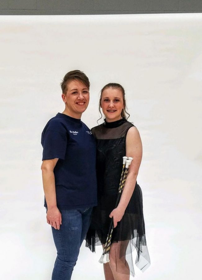 Grace and her coach, Heather, pose for a photo together during Graces first year of competition baton twirling.