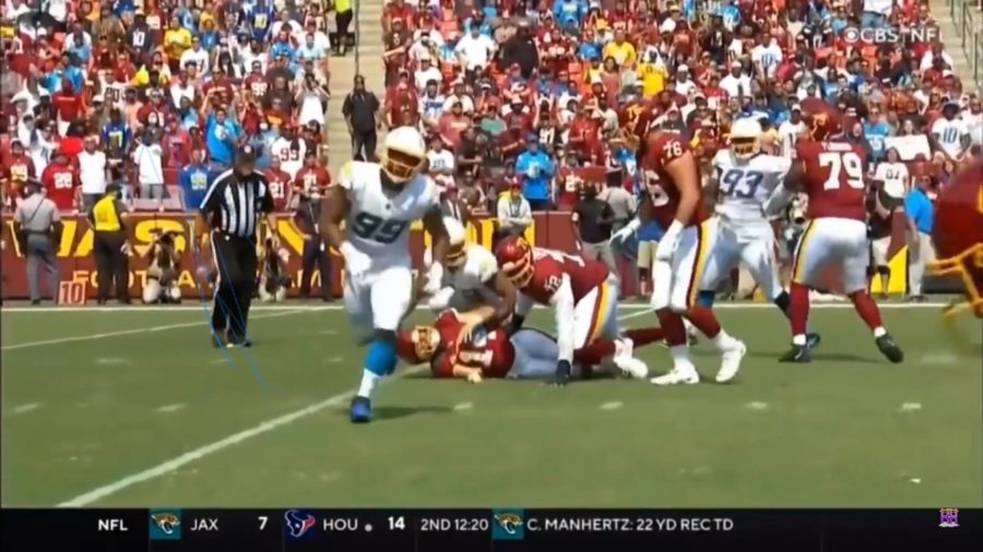 Washington quarterback, Ryan Fitzpatrick on the ground after getting hit by a Charger defender. Also if you look toward the top left, you can see myself with my long hair wearing a burgundy #99 jersey. My best friend, Landon Small, is next to me wearing the blue # 85 jersey, but his head is cut off. 