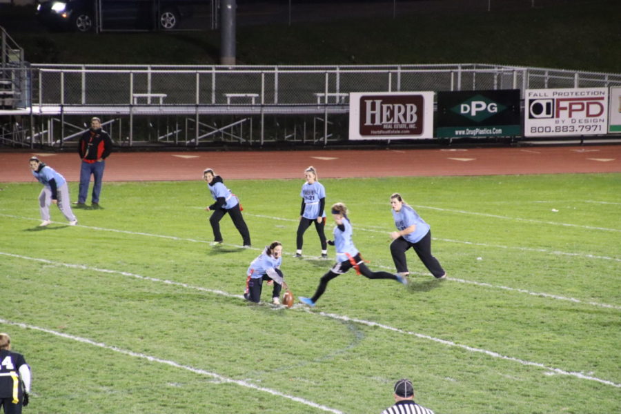 Seniors kicking the ball at Powderpuff 2021. 