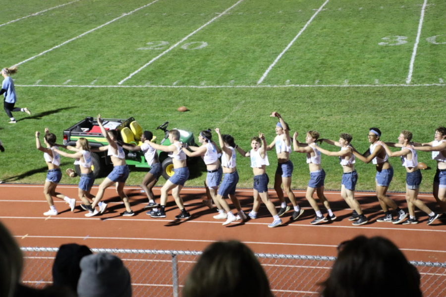 The cheerleaders forming a conga line down the track. 