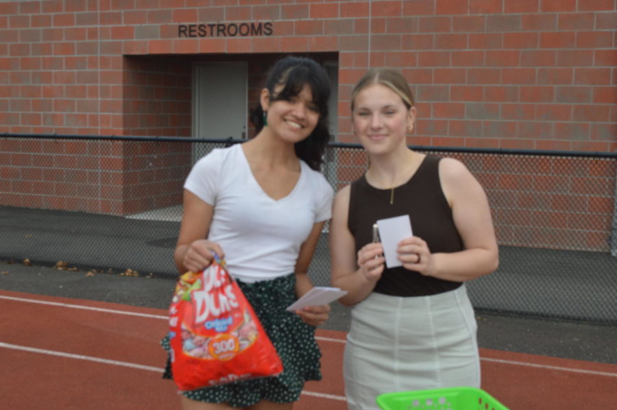 Impact Club members, Kara Friend and Bianca Samuel, running kindness note station with notes and lollipops to give out to friends and teachers 