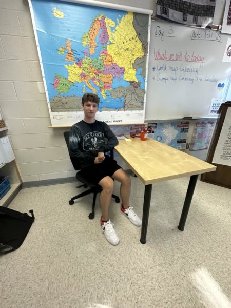 Me sitting at my desk in the classroom