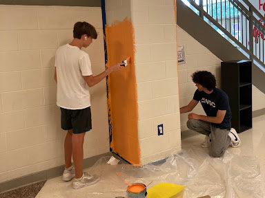 BASH students painting the hallways of their high school
