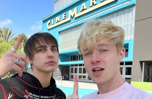 Sam and Colby standing outside the movie theater on the premere of their movie.