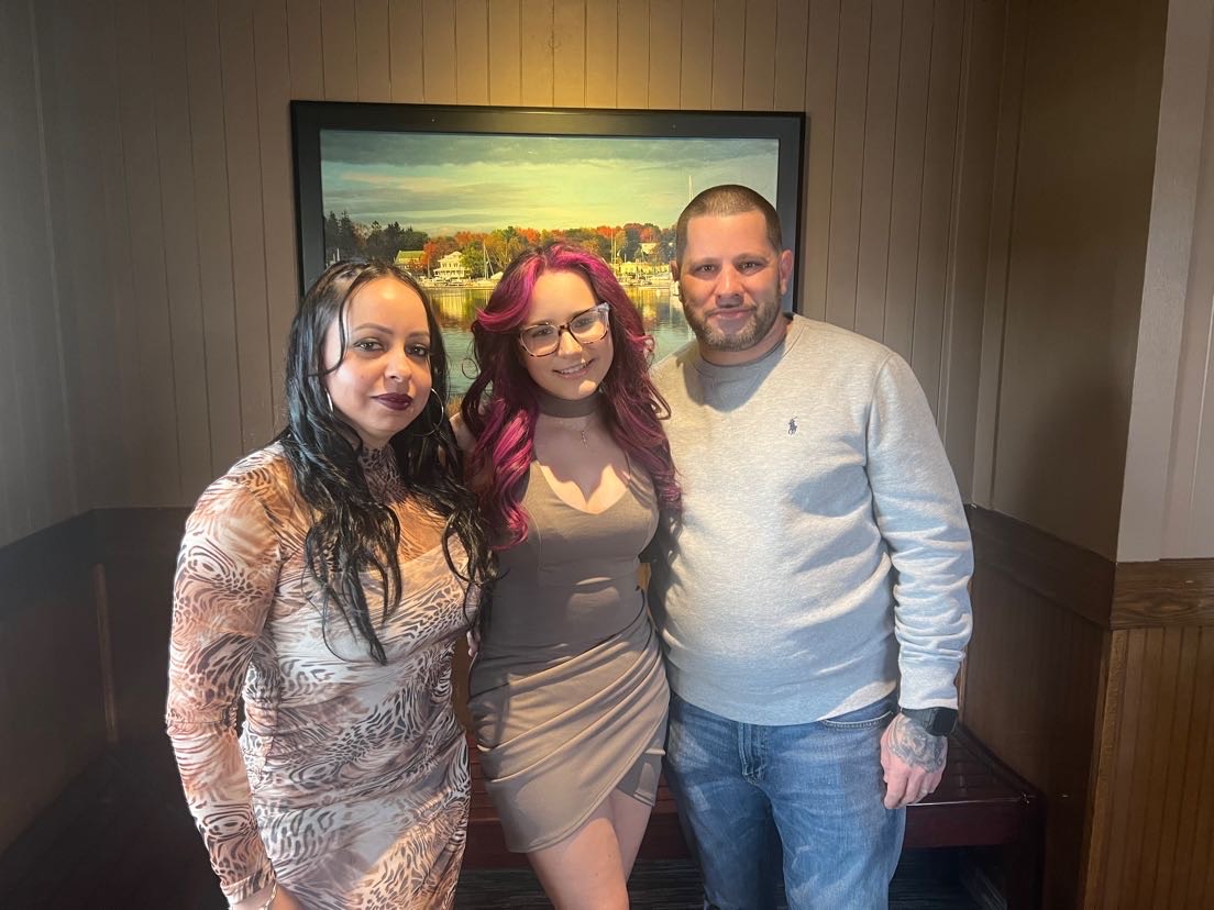 Kayla Jomarron, standing with her parents William and Maria Jomarron, on her 18th birthday at Red Lobster.