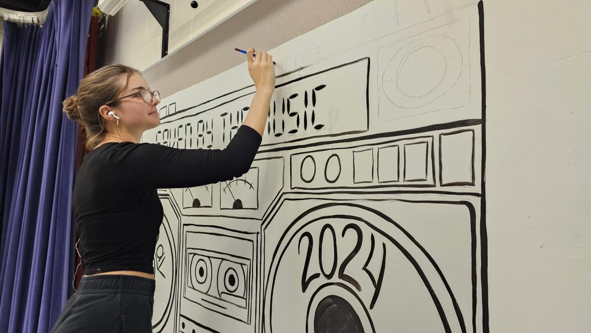 Hunter Healy working on the backdrop for Live Day.