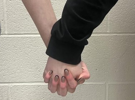 BASH students holding hands as they show their platonic love for one another. 