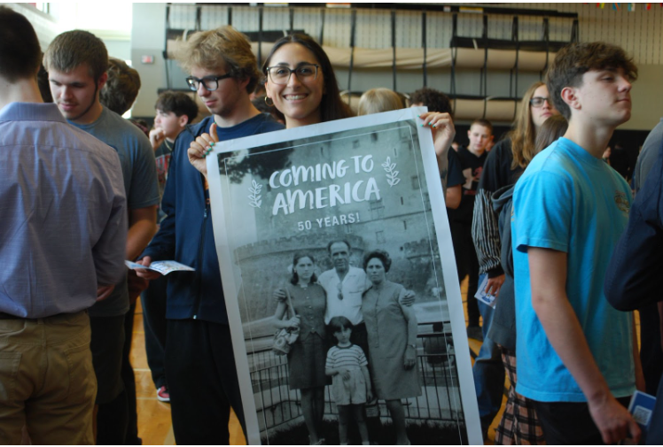 Mrs. Snyder holding a picture of her family immigrating from Italy to the US