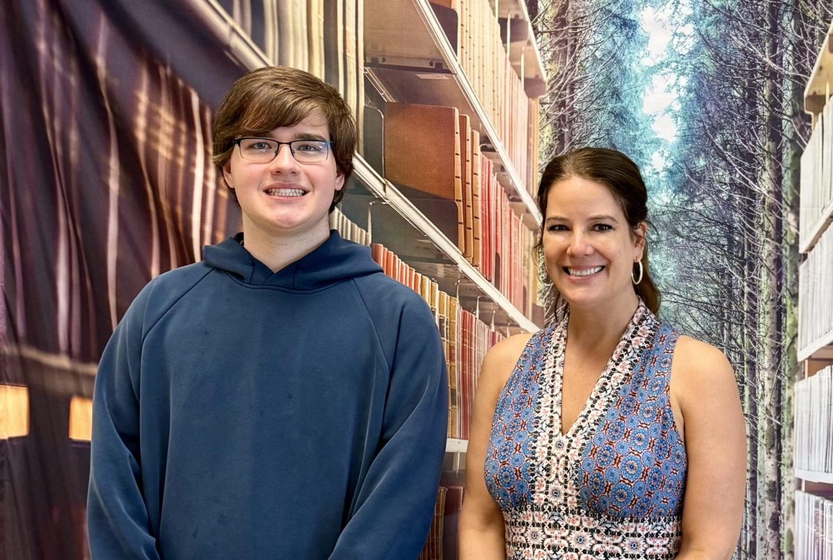 John Loos with the Cub's advisor, Mrs. Schaarschmidt, during a Cub meeting. 