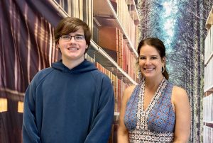 John Loos with the Cub's advisor, Mrs. Schaarschmidt, during a Cub meeting. 