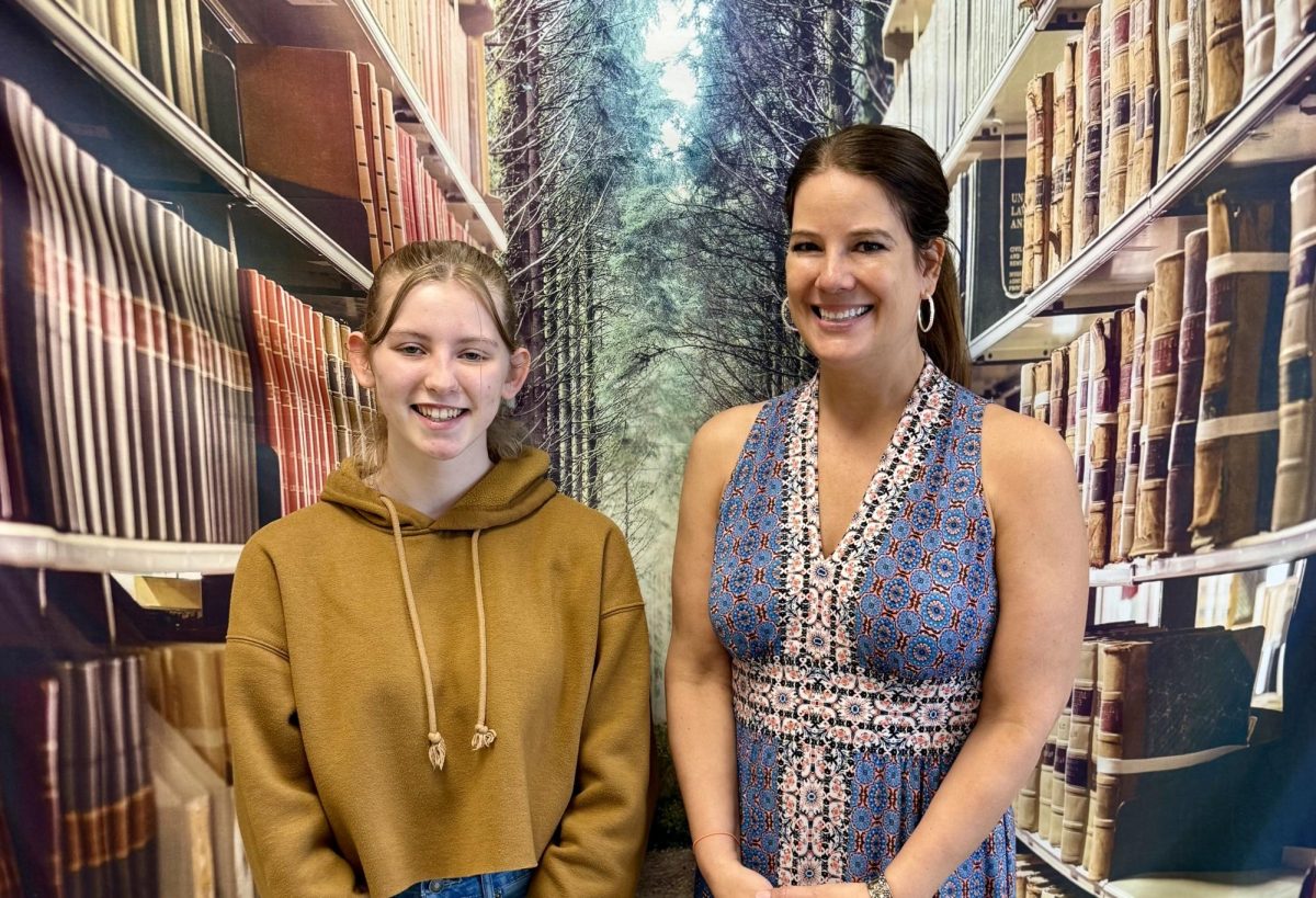 Hailey Gress and Mrs. Schaarschmidt standing together during one of the Cub's final meetings for the school year.