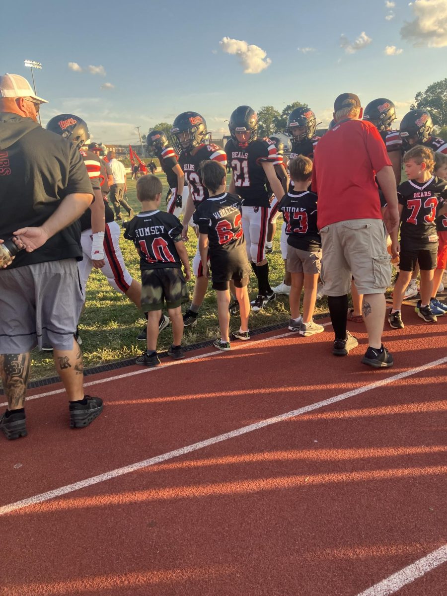 Little leagues high fiving the Boyertown bears as they walk out
