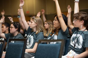 Hailey Gress raising hand to ask a question