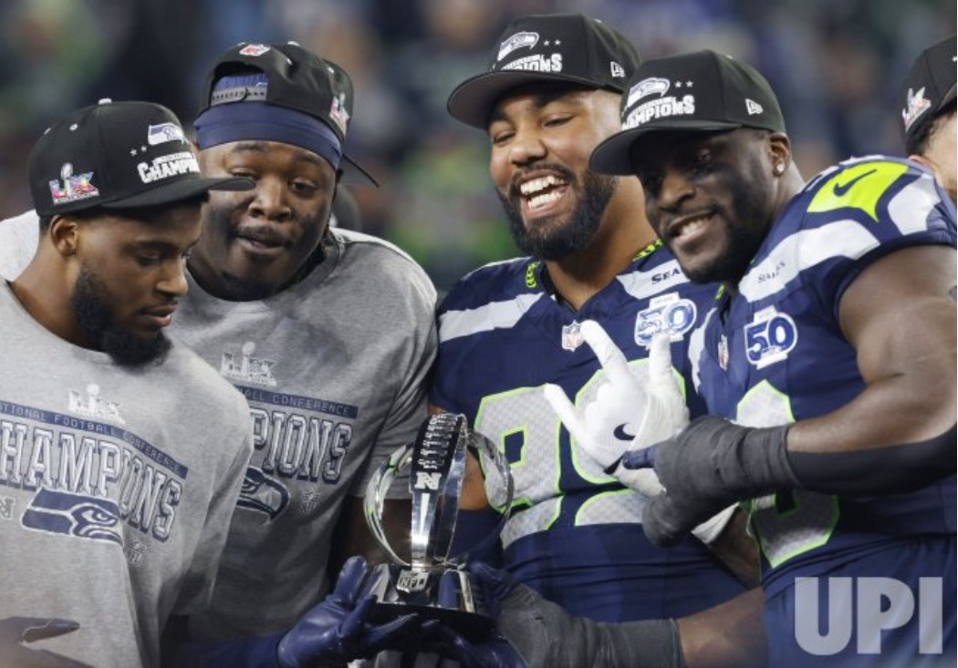 Seahawks players raising the George Halas Trophy.